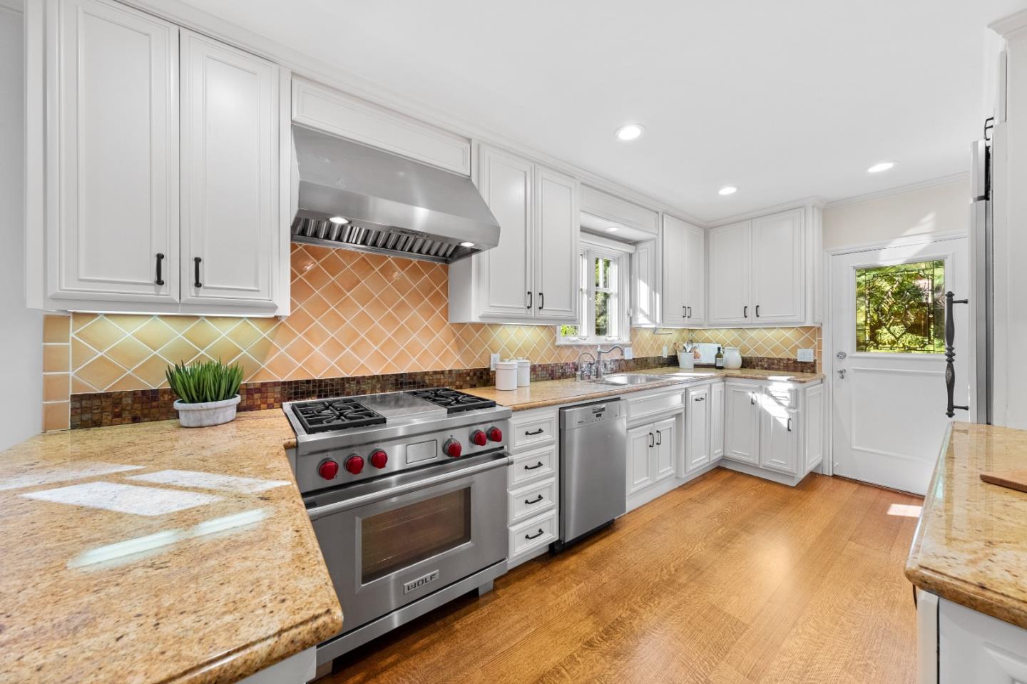 425 Dorchester Road San Mateo, CA 94402 - Photo 16 of 61 a kitchen with a stove a sink and a refrigerator