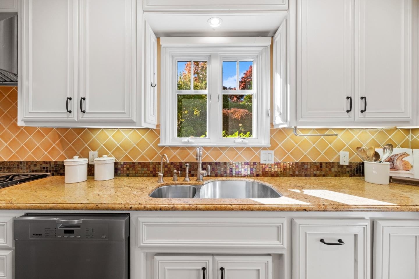 425 Dorchester Road San Mateo, CA 94402 - Photo 19 of 61 a kitchen with granite countertop a sink and a white cabinets