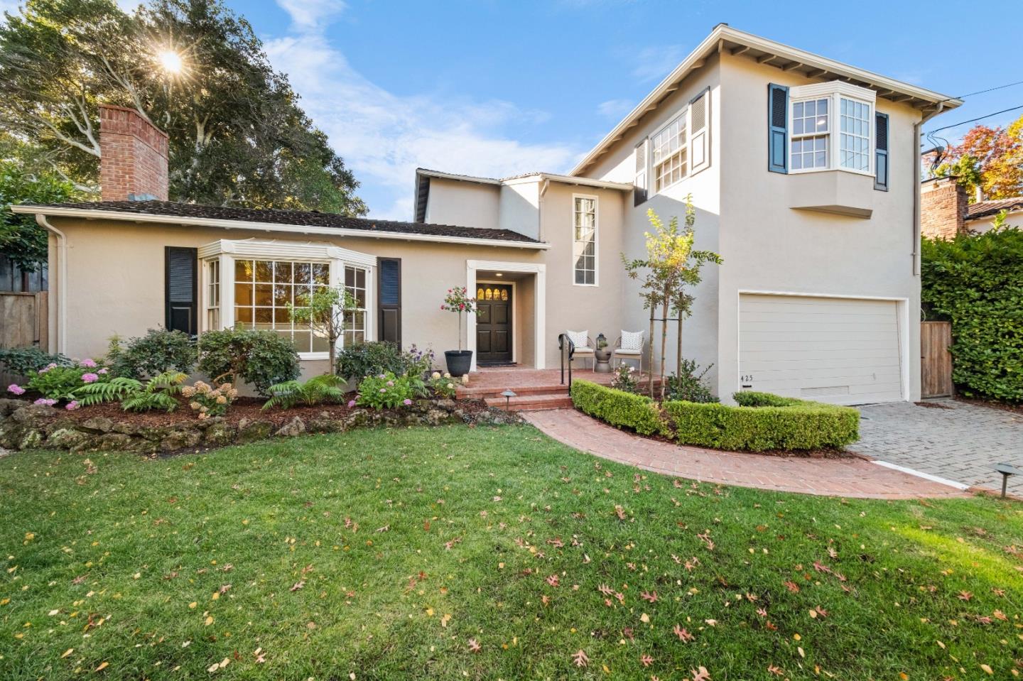 425 Dorchester Road San Mateo, CA 94402 - Photo 2 of 61 a front view of a house with a garden and plants