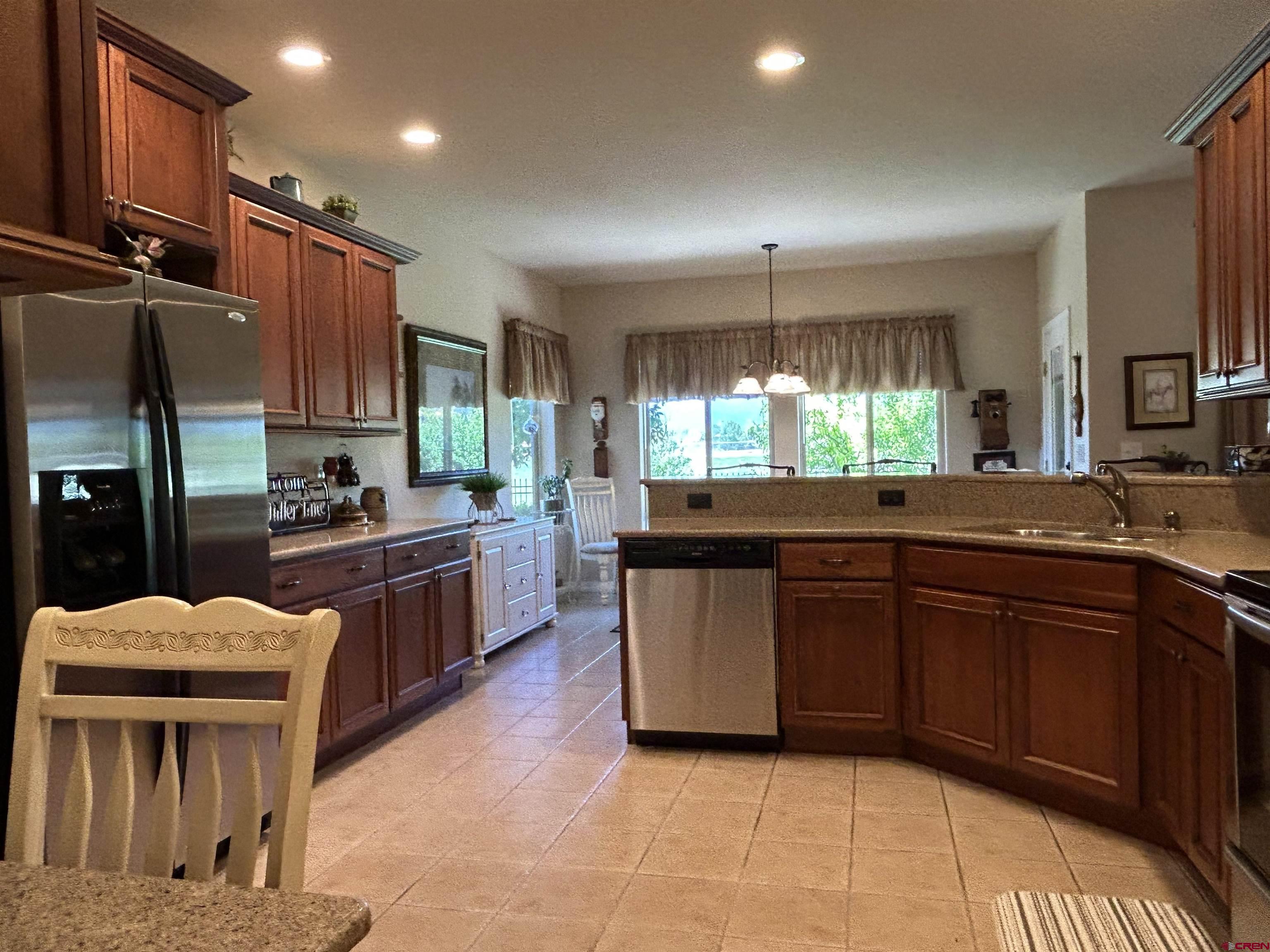 850 Southeast Pinyon Street Cedaredge, CO 81413 - Photo 10 of 45 a kitchen with stainless steel appliances granite countertop a stove a sink and a microwave