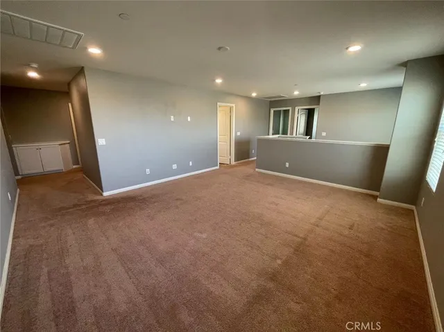 a view of a big room with windows and stairs