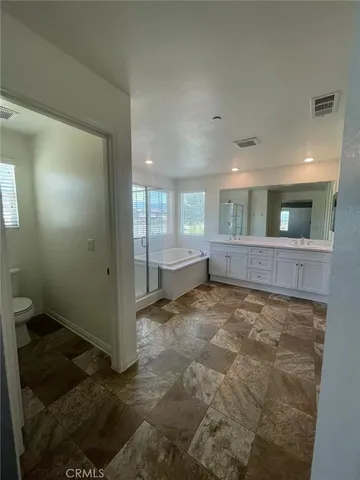 en empty room with window and wooden floor