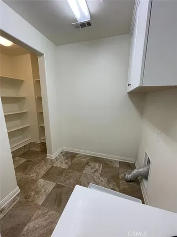 a view of room with racks on the wall