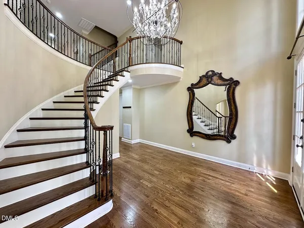 a view of entryway and hall with wooden floor