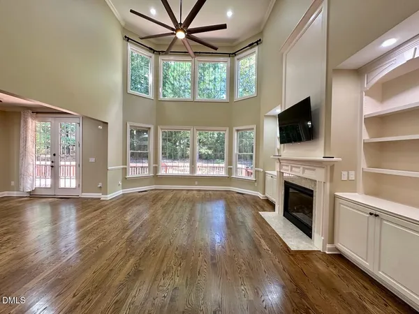 a view of an empty room with a fireplace and a window