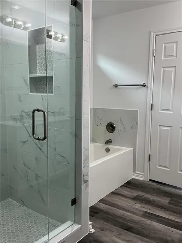a bathroom with a bathtub and a shower