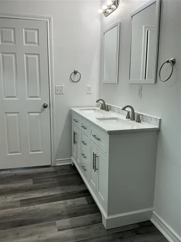 a bathroom with a double vanity sink and mirror