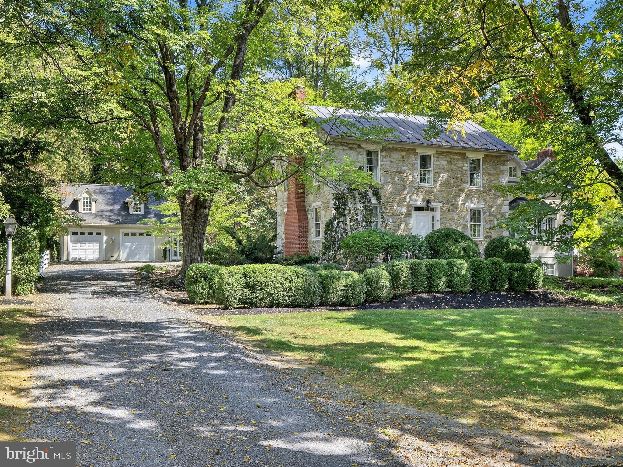 265 North Old Stonehouse Road South Carlisle, PA 17015 - Photo 1 of 100 a view of a white house next to a yard with big trees