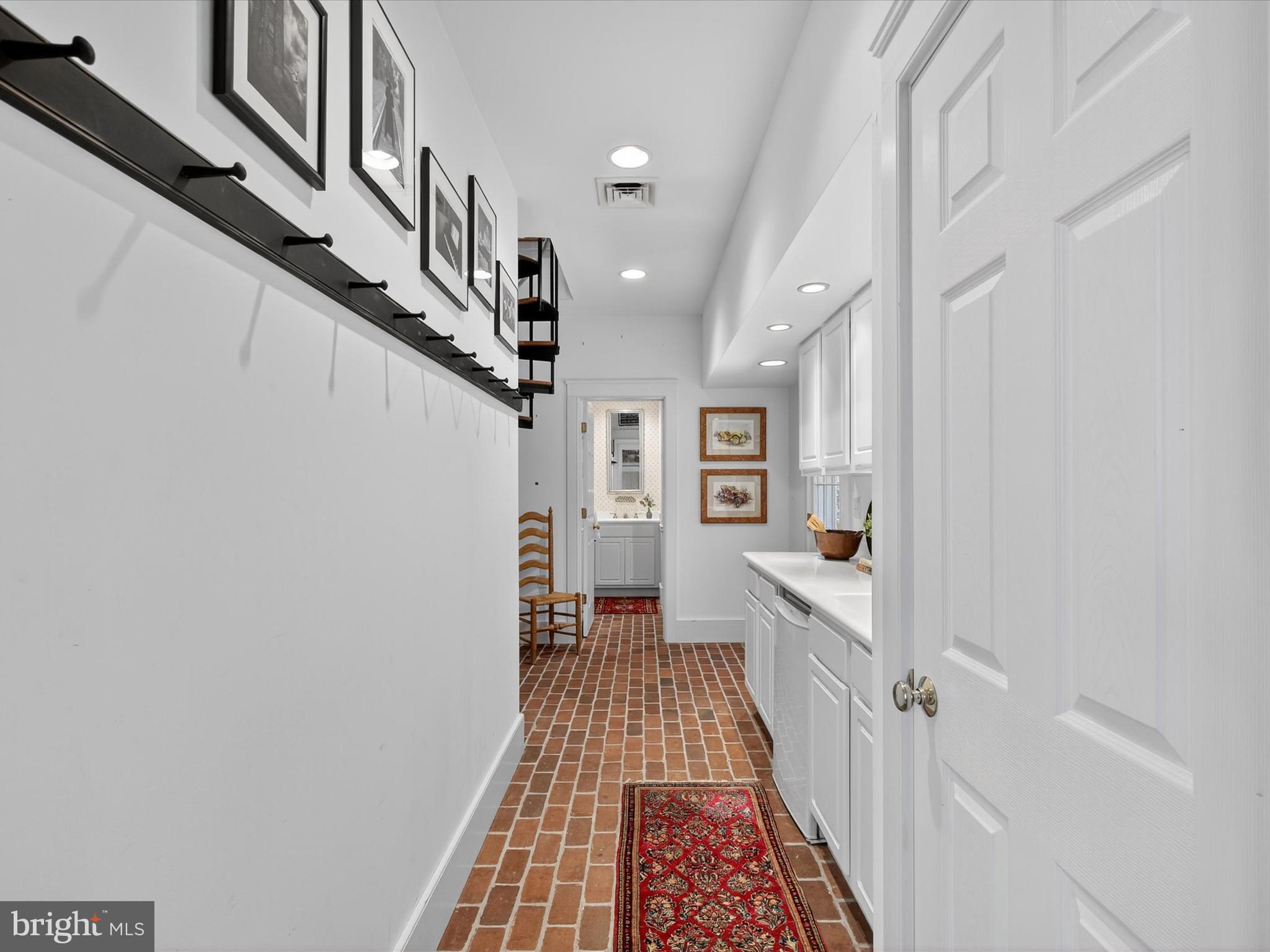 265 North Old Stonehouse Road South Carlisle, PA 17015 - Photo 90 of 100 a hallway with white cabinets and chandelier