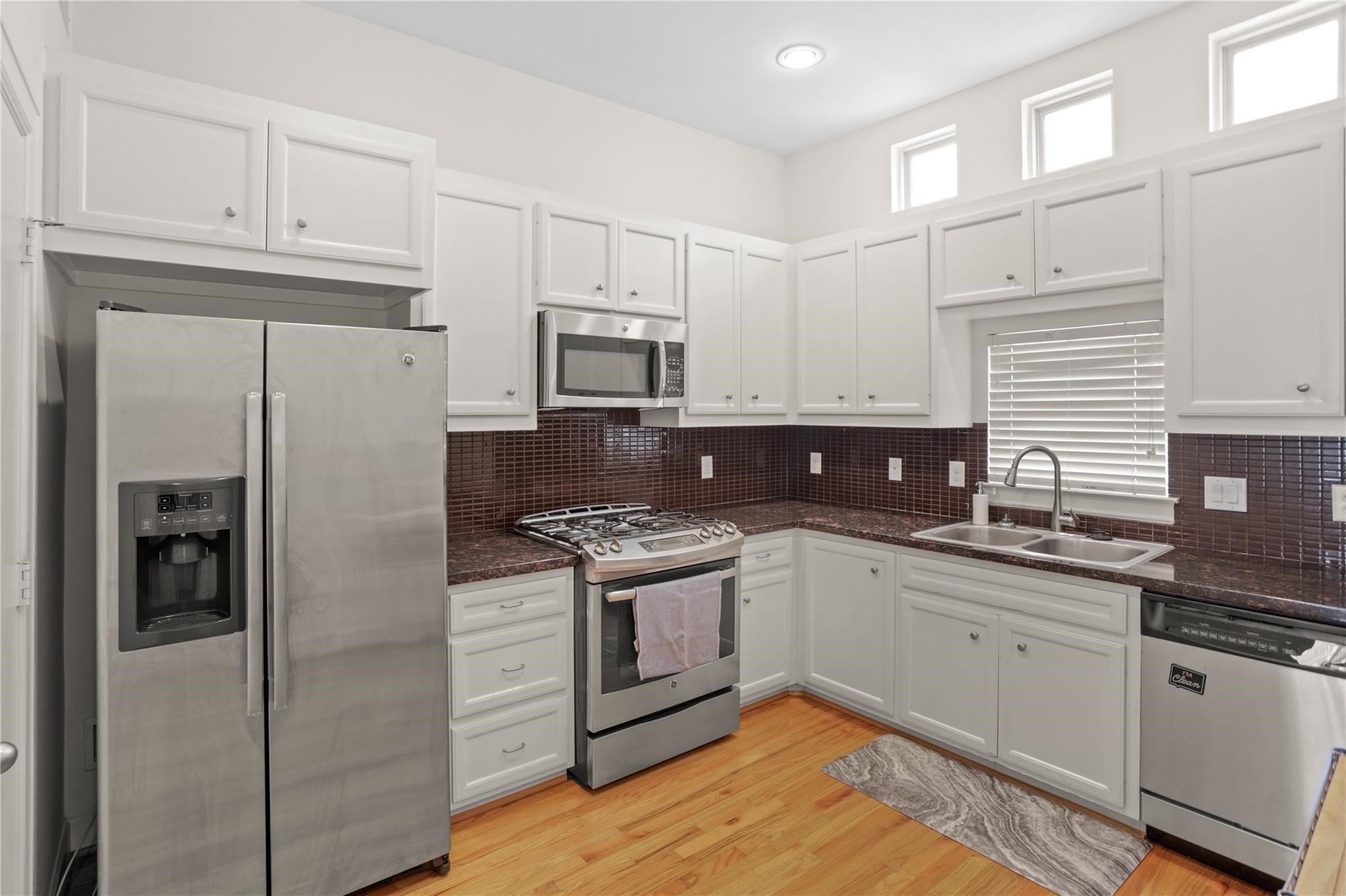 2710 Hullsmith Drive, Unit 604 Houston, TX 77063 - Photo 12 of 27 a kitchen with stainless steel appliances granite countertop a refrigerator sink and cabinets