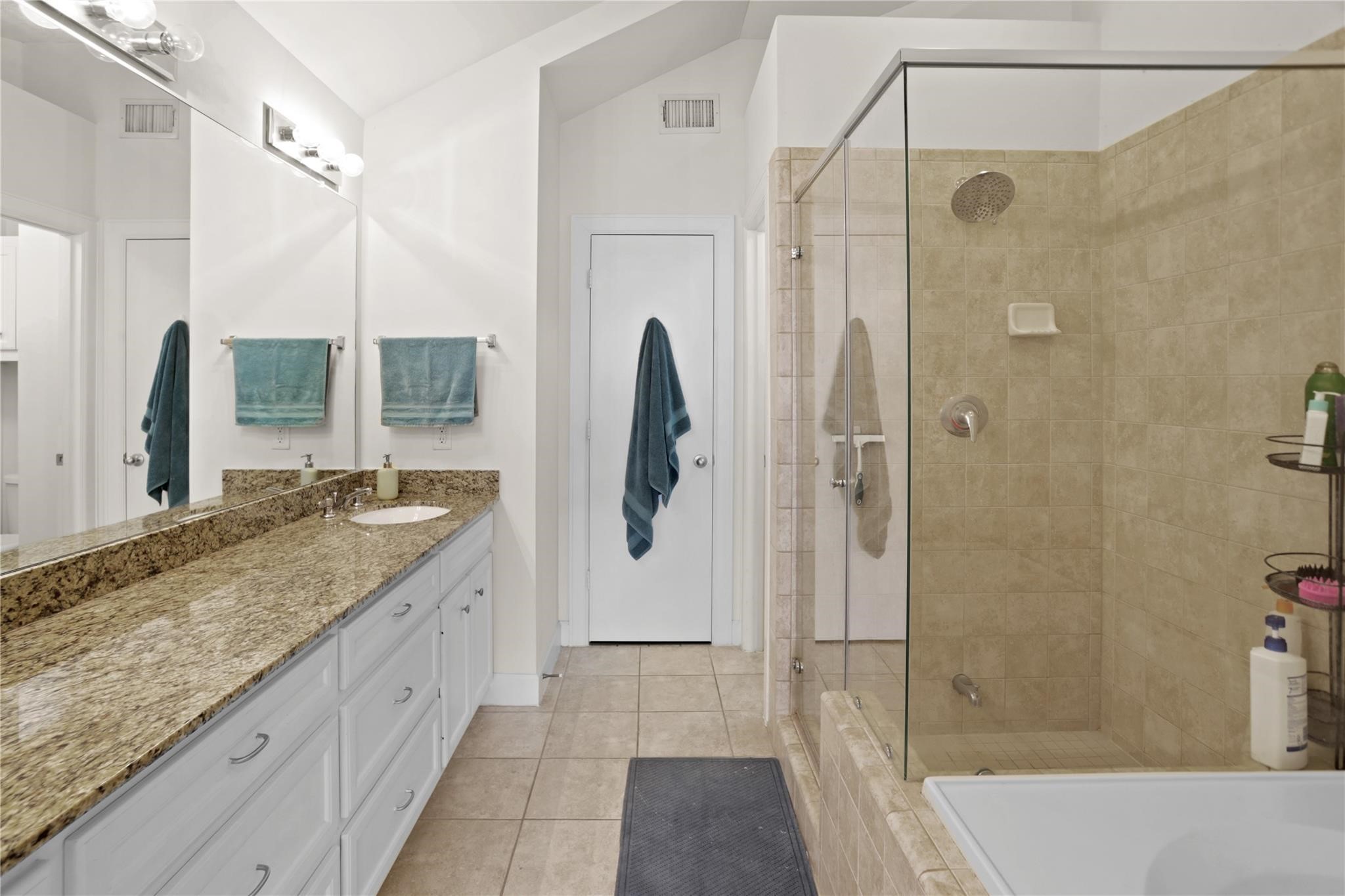 2710 Hullsmith Drive, Unit 604 Houston, TX 77063 - Photo 17 of 27 a bathroom with a granite countertop sink a shower and a mirror