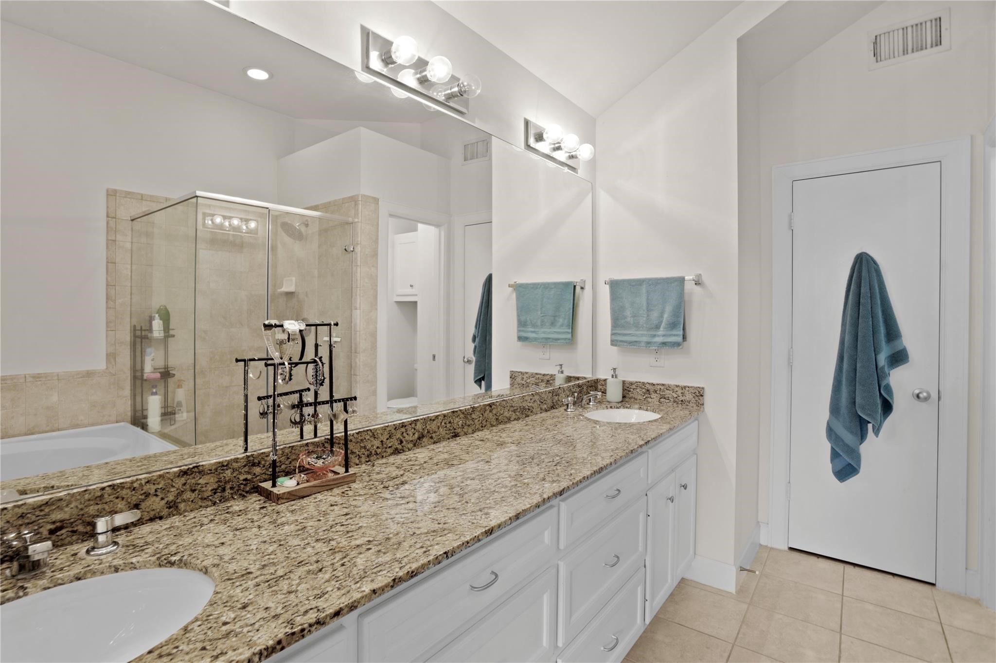 2710 Hullsmith Drive, Unit 604 Houston, TX 77063 - Photo 4 of 27 a bathroom with a granite countertop sink and a mirror