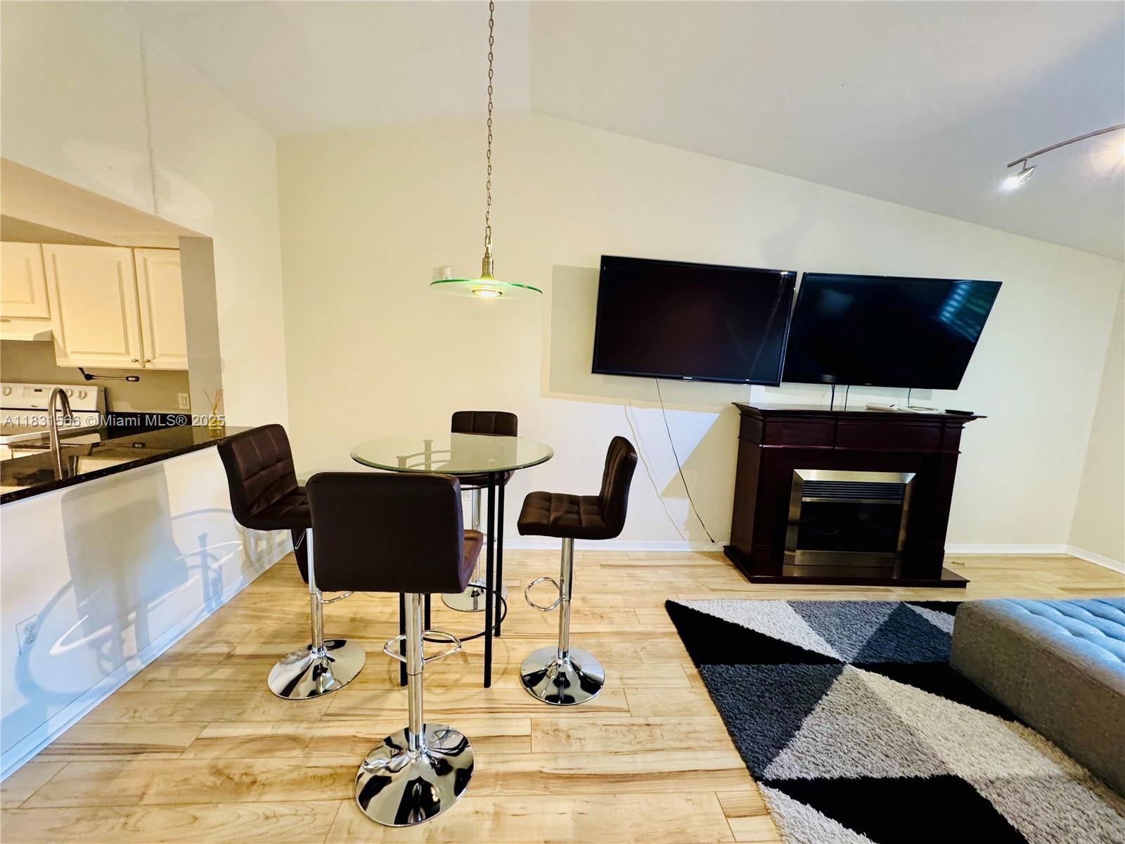 8244 Key Royal Circle, Unit 633 Naples, FL 34119 - Photo 11 of 37 a living room with furniture and a fireplace