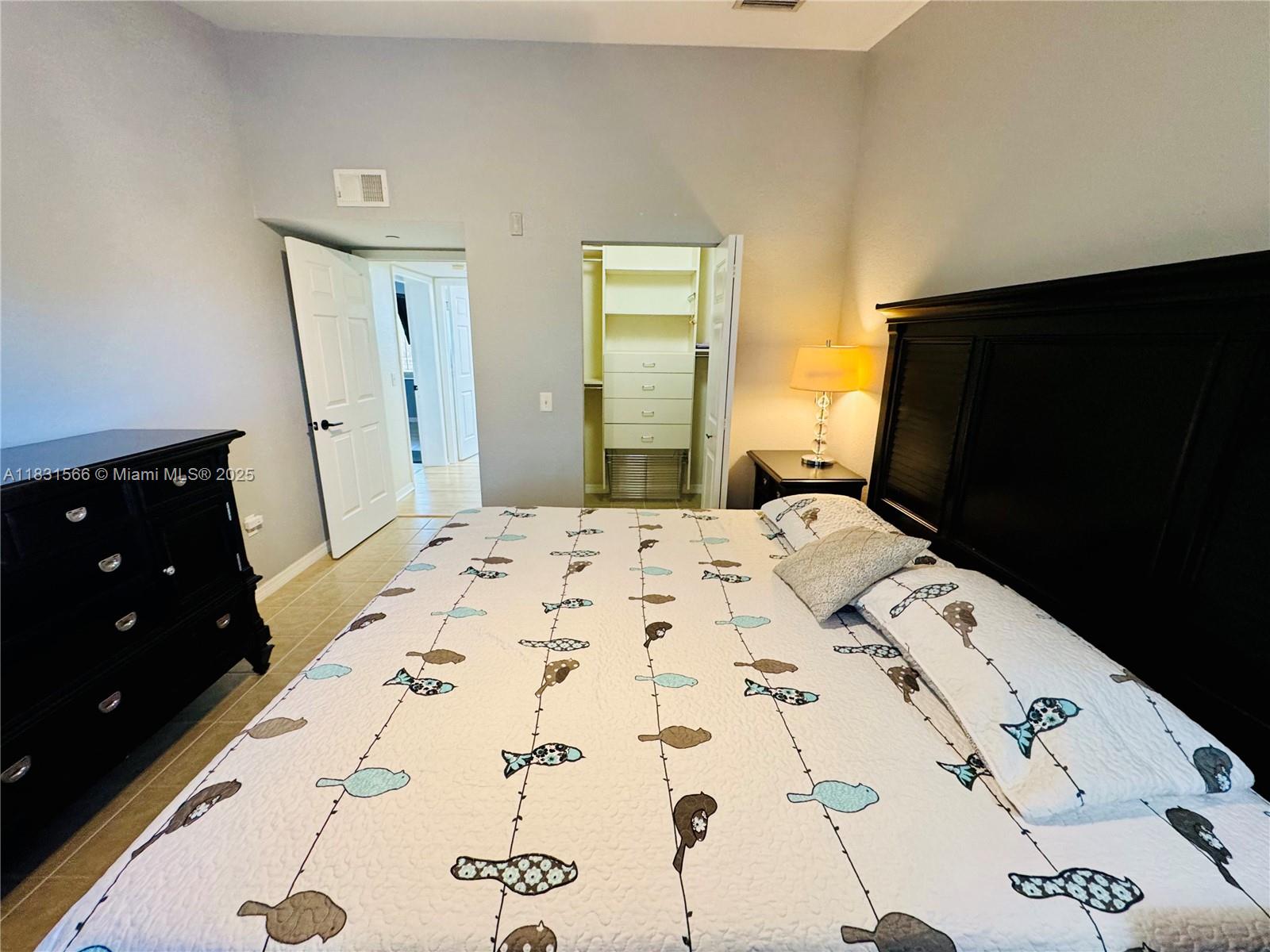 8244 Key Royal Circle, Unit 633 Naples, FL 34119 - Photo 17 of 37 a bedroom with a bed and a dresser