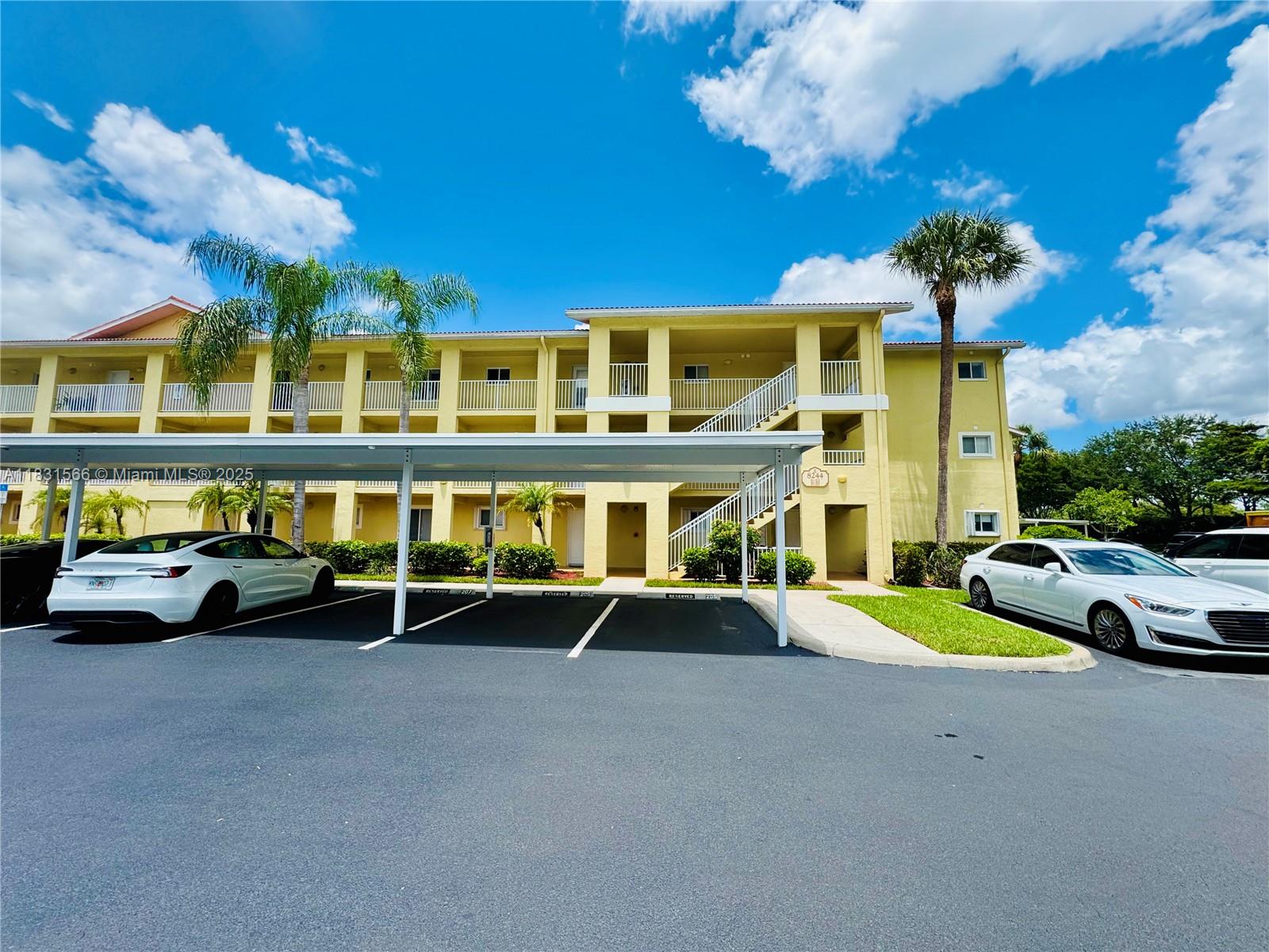 8244 Key Royal Circle, Unit 633 Naples, FL 34119 - Photo 2 of 37 a view of a building with a swimming pool table and chairs