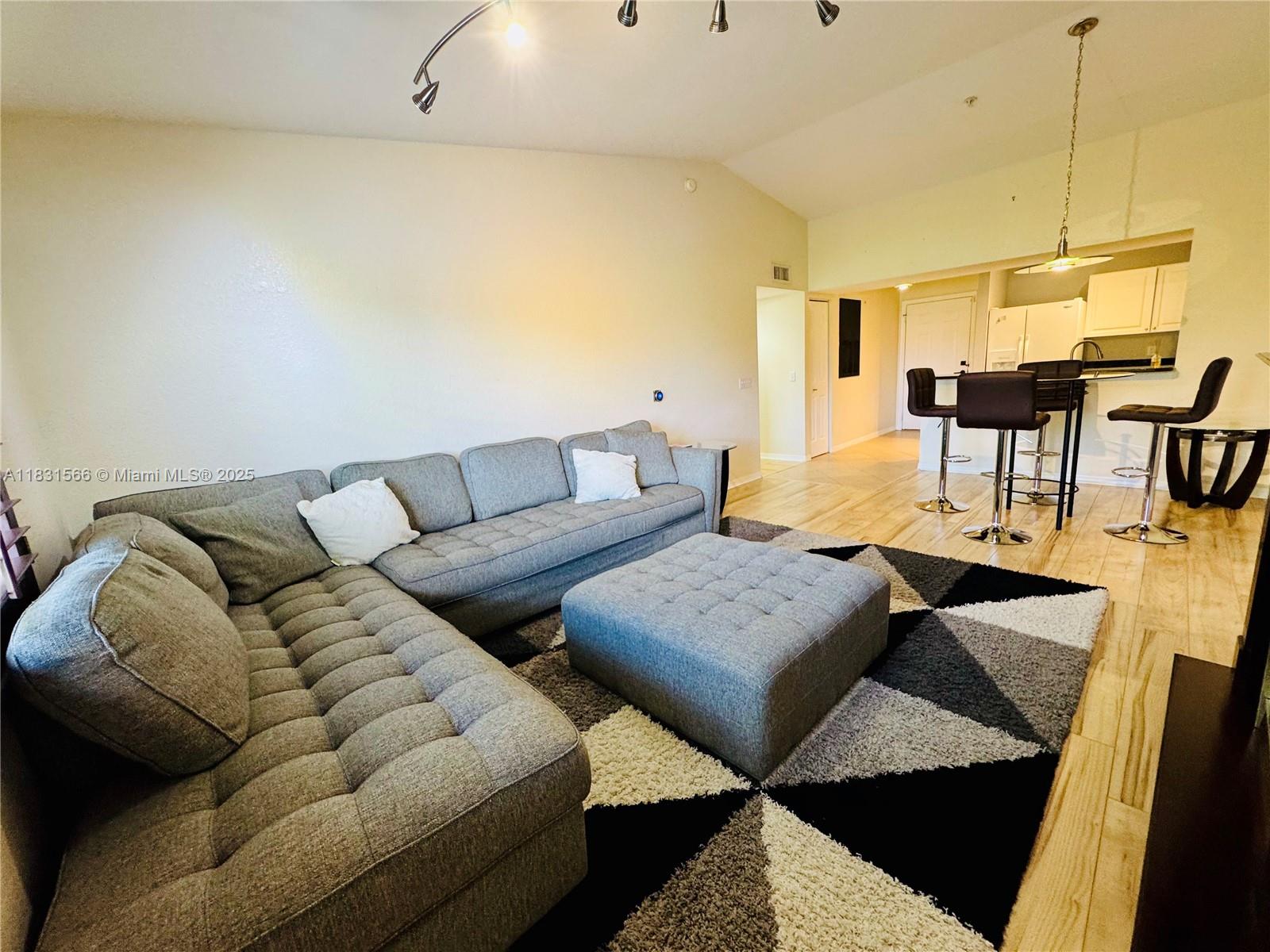 8244 Key Royal Circle, Unit 633 Naples, FL 34119 - Photo 22 of 37 a living room with furniture and wooden floor