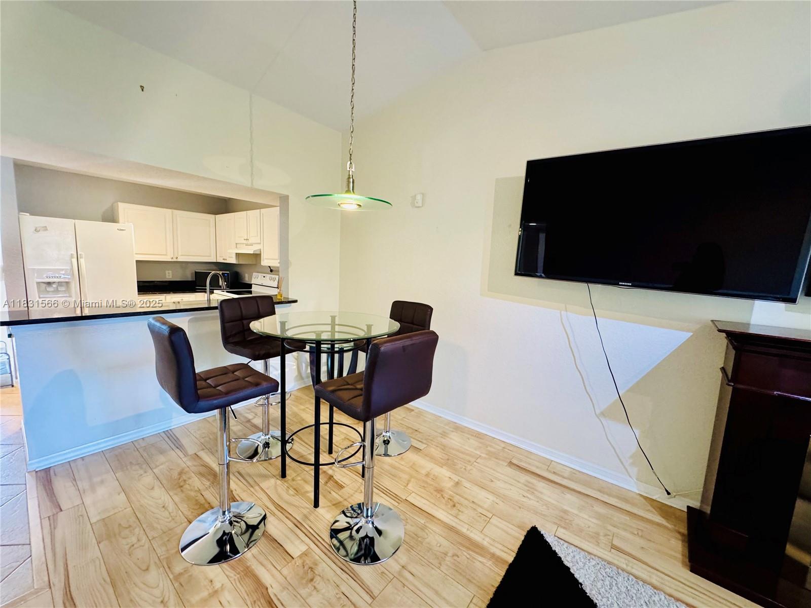 8244 Key Royal Circle, Unit 633 Naples, FL 34119 - Photo 24 of 37 a living room with furniture and a flat screen tv