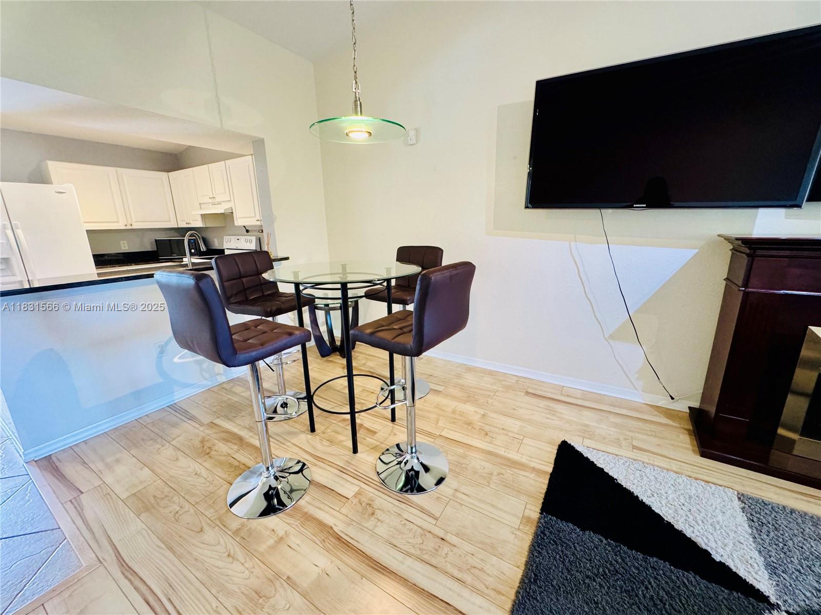 8244 Key Royal Circle, Unit 633 Naples, FL 34119 - Photo 25 of 37 a living room with furniture and a flat screen tv