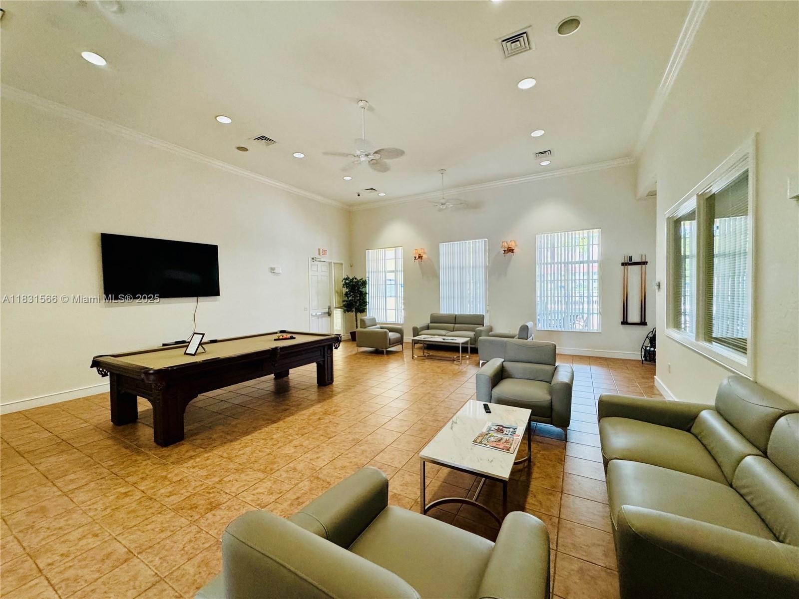 8244 Key Royal Circle, Unit 633 Naples, FL 34119 - Photo 26 of 37 a living room with furniture and a flat screen tv