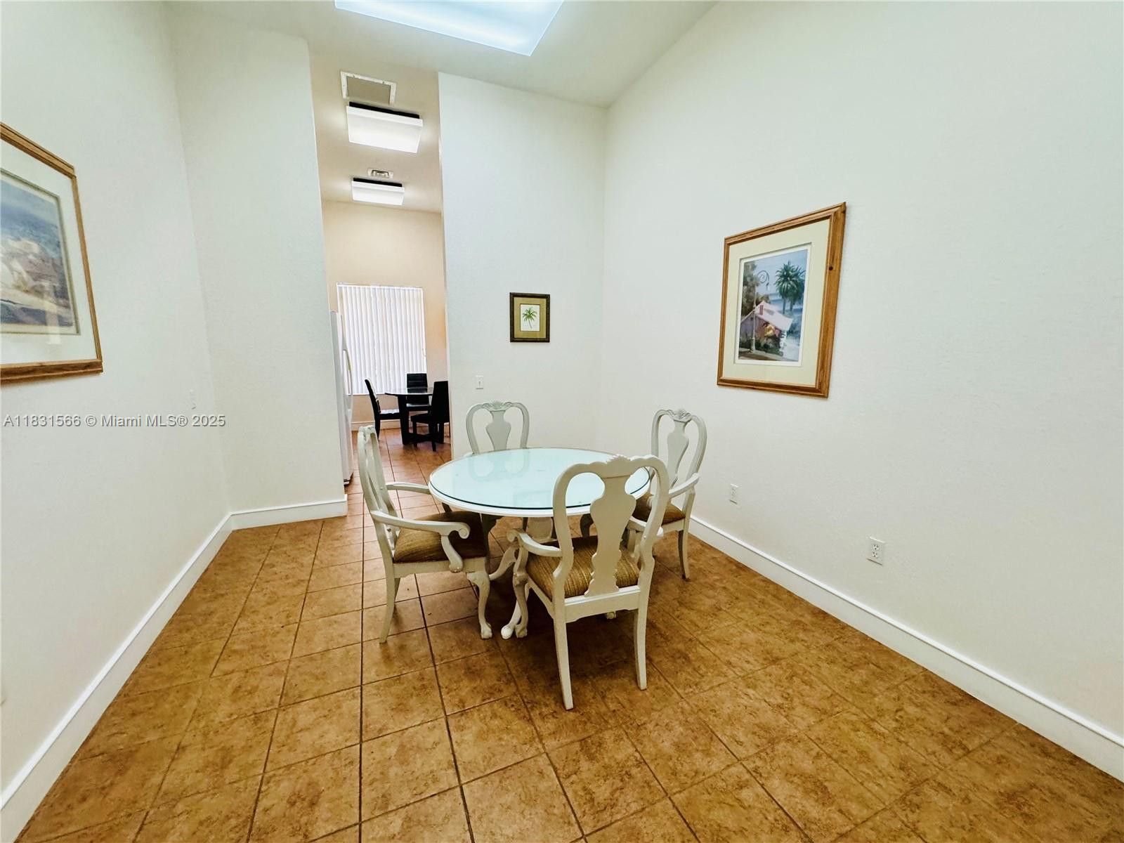 8244 Key Royal Circle, Unit 633 Naples, FL 34119 - Photo 29 of 37 a dining room with a table and chairs