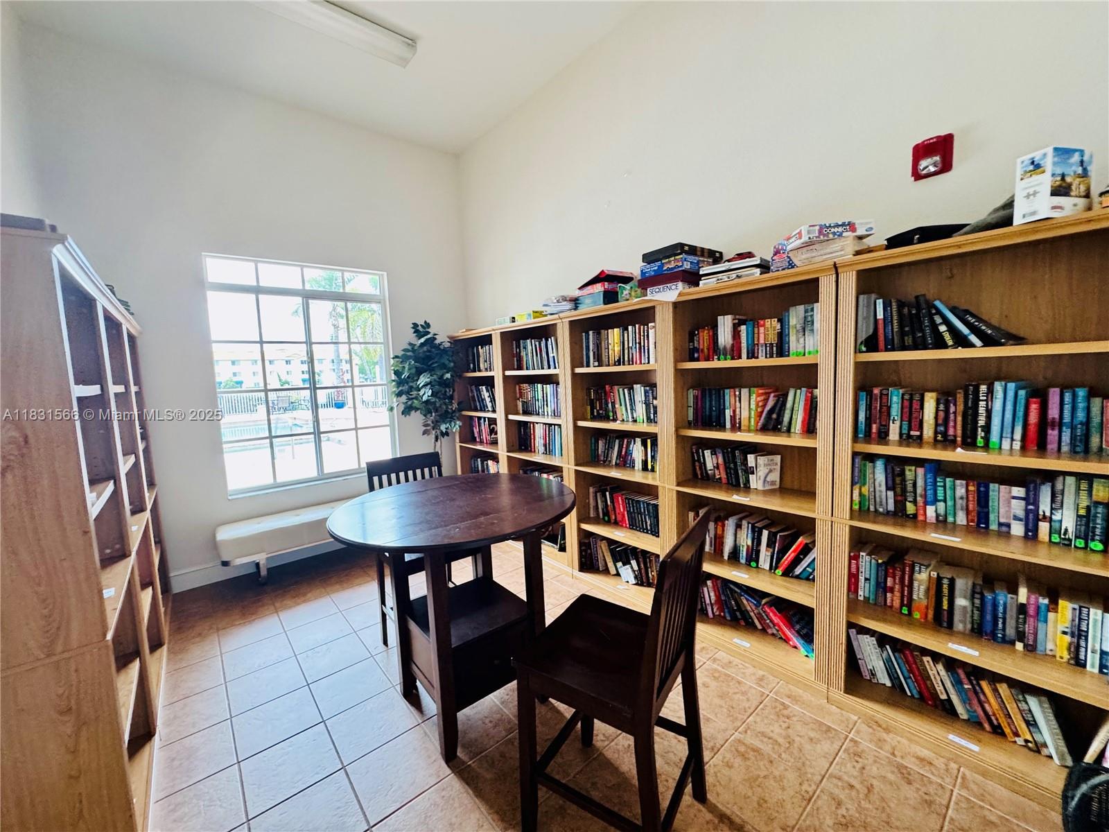 8244 Key Royal Circle, Unit 633 Naples, FL 34119 - Photo 32 of 37 a view of a workspace with furniture and a book shelf