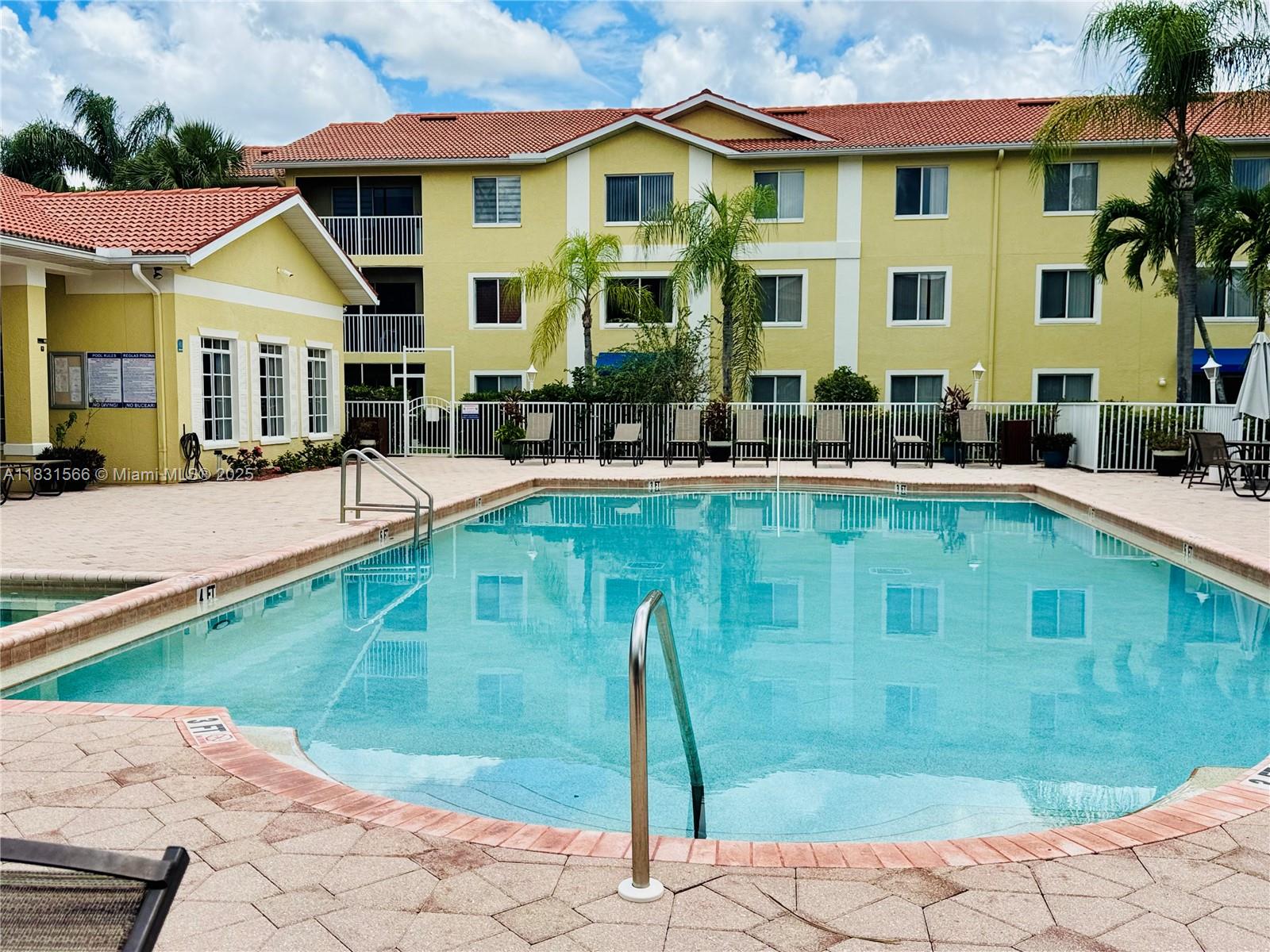 8244 Key Royal Circle, Unit 633 Naples, FL 34119 - Photo 34 of 37 a front view of a house with swimming pool porch and furniture