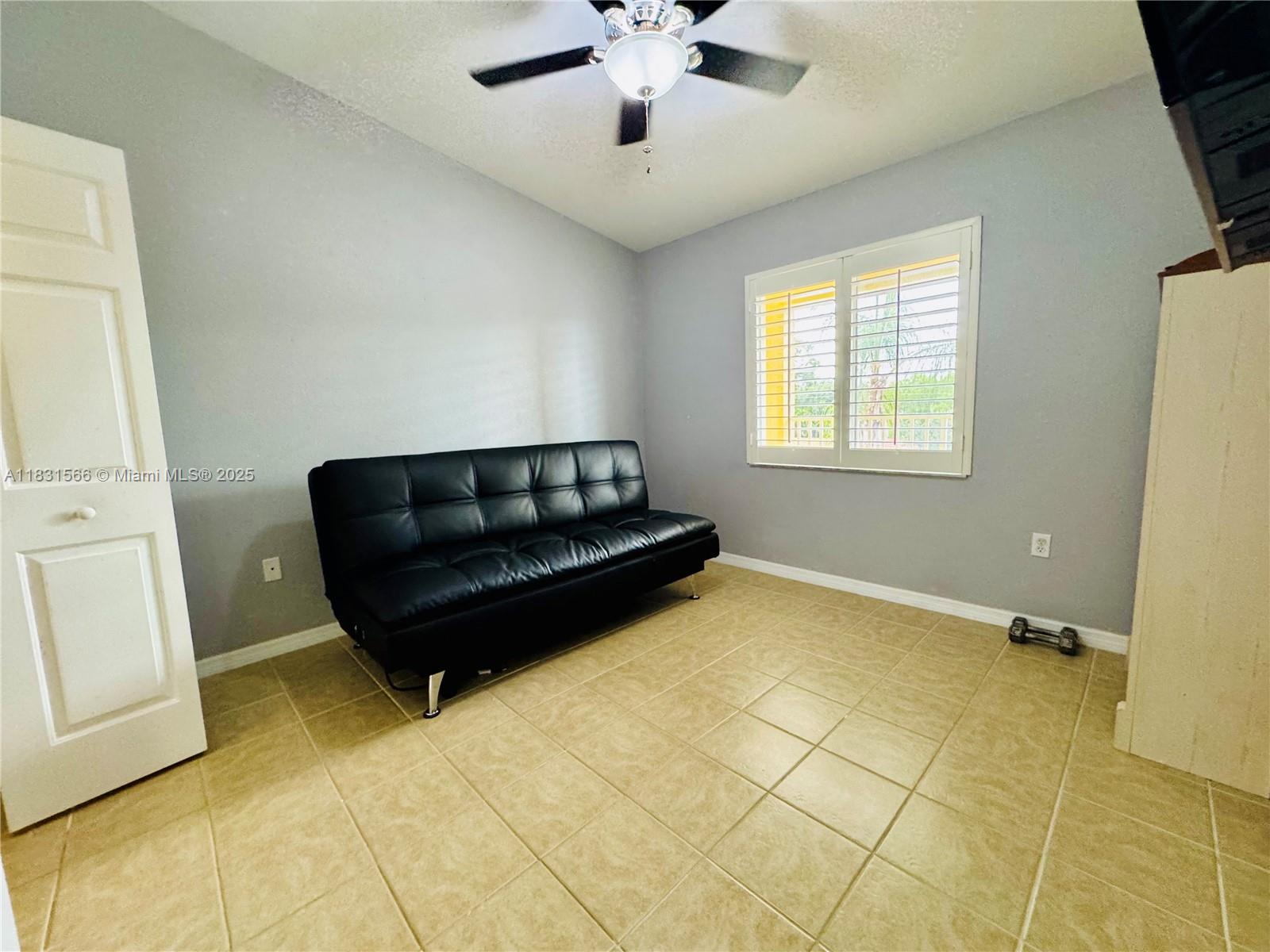8244 Key Royal Circle, Unit 633 Naples, FL 34119 - Photo 7 of 37 a living room with furniture and a chandelier