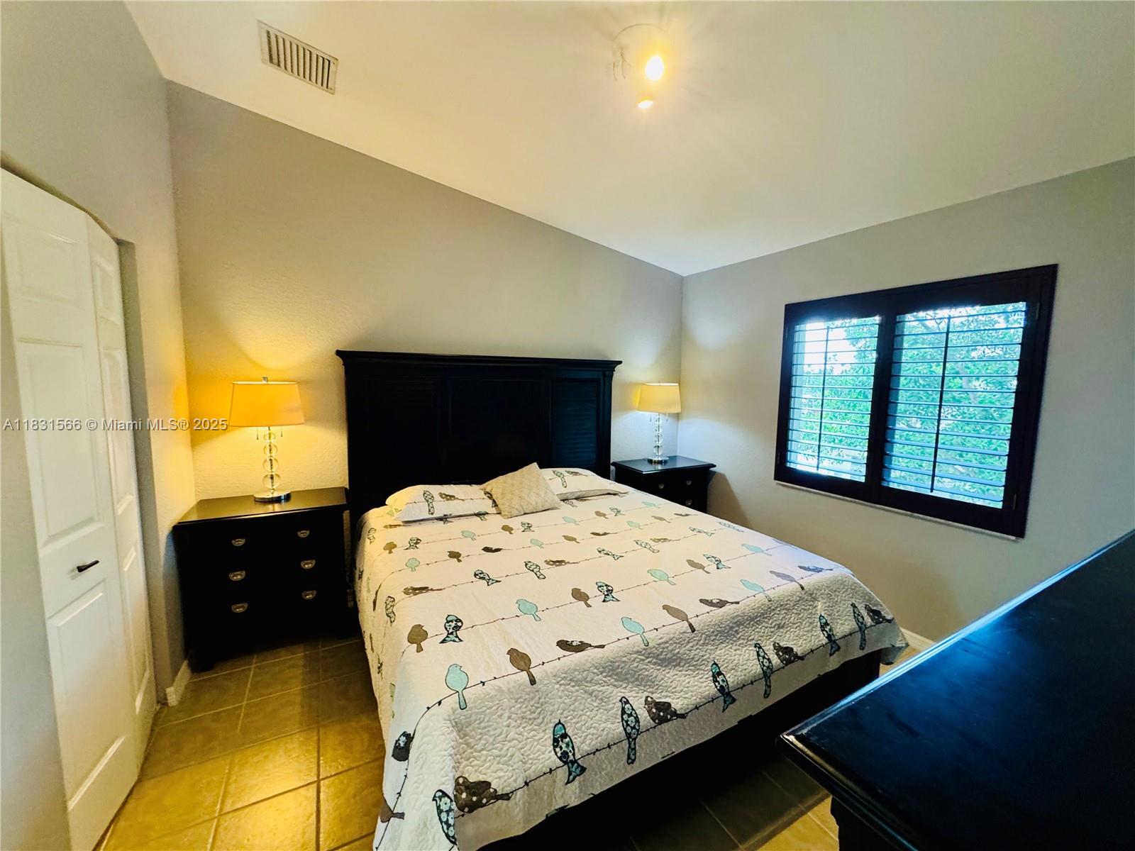 8244 Key Royal Circle, Unit 633 Naples, FL 34119 - Photo 8 of 37 a bedroom with a bed and window