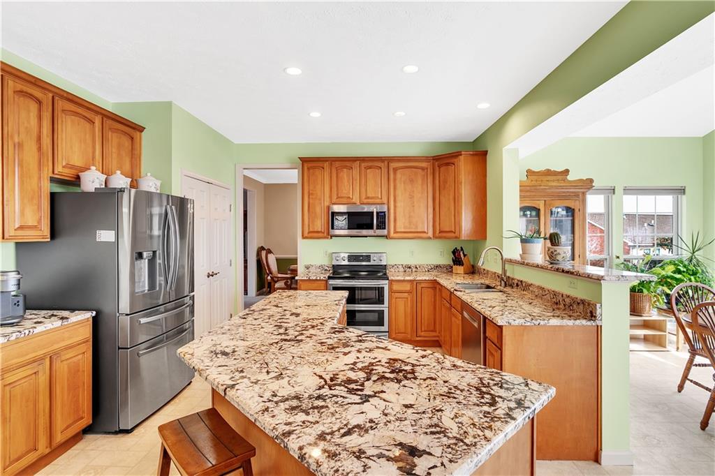 403 Meadow View Drive McKees Rocks, PA 15136 - Photo 11 of 25 a kitchen with stainless steel appliances granite countertop sink stove refrigerator and cabinets