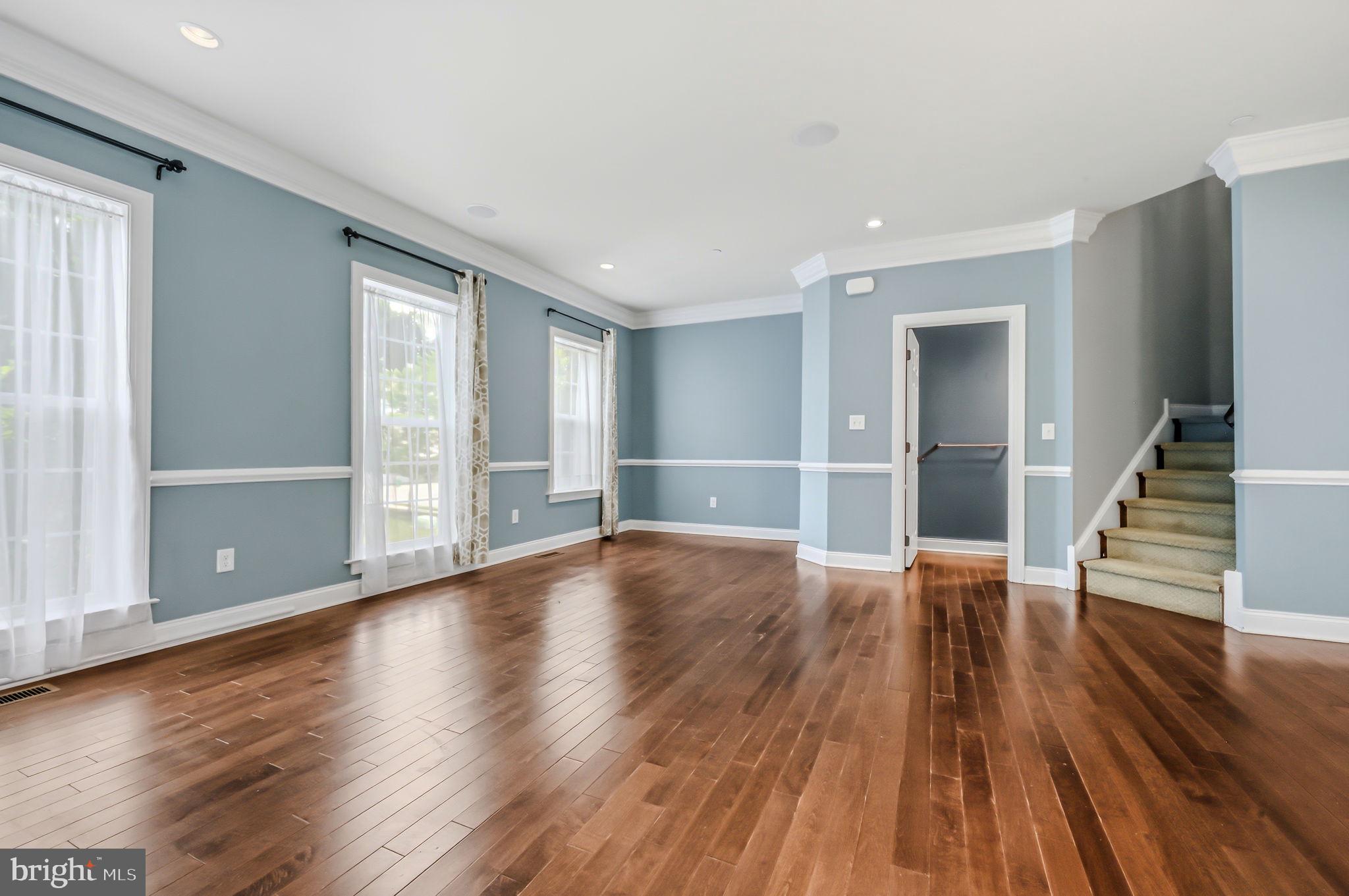 208 Jackdaw Alley, Unit 208 Springfield, PA 19064 - Photo 27 of 49 an empty room with wooden floor and windows