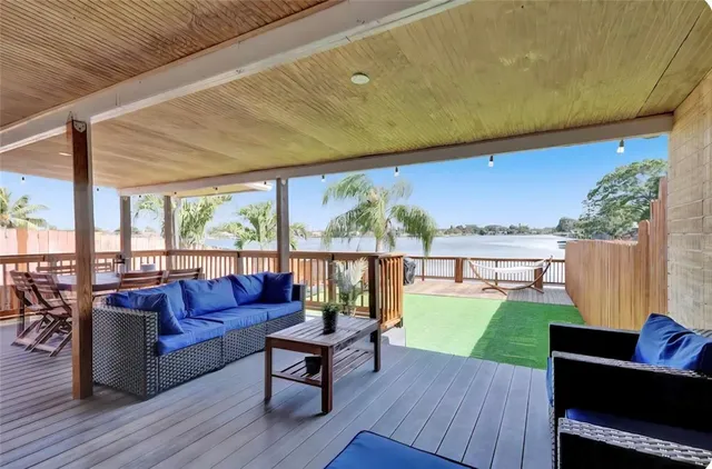 a living room with couch and a floor to ceiling window