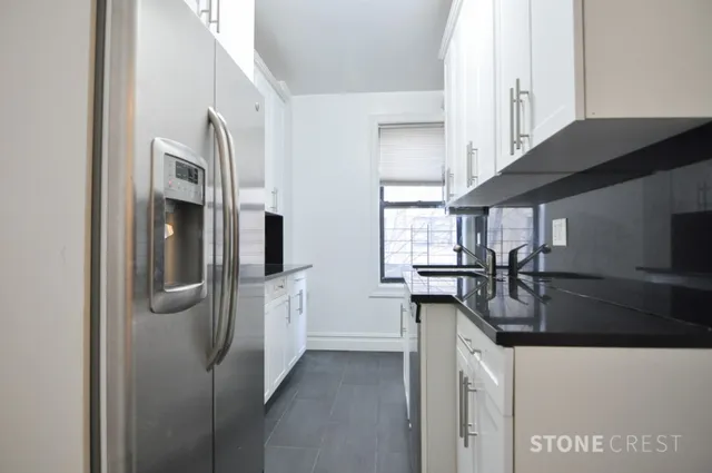 a kitchen with stainless steel appliances granite countertop a refrigerator and a sink