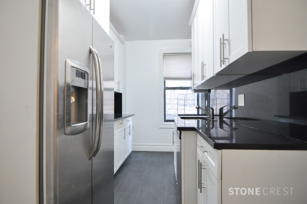 290 Riverside Drive, Unit 2B Manhattan, NY 10025 - Photo 5 of 17 a kitchen with stainless steel appliances granite countertop a refrigerator and a sink