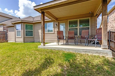 a view of a house with backyard and porch