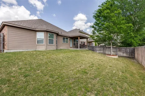 a view of a house with a yard and a garden