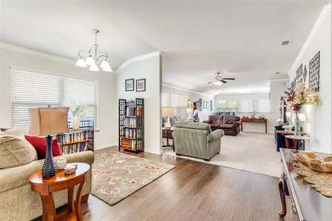 a living room with furniture and a chandelier