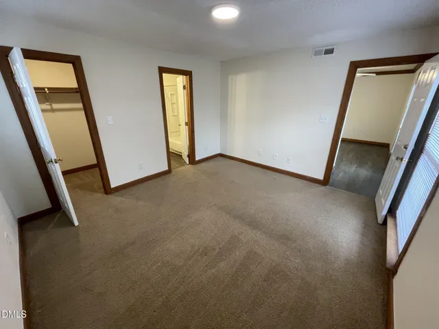 a view of a hallway view with wooden floor and entryway