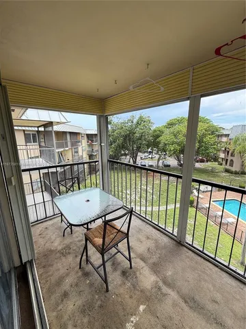 a view of a porch with furniture and wooden floor
