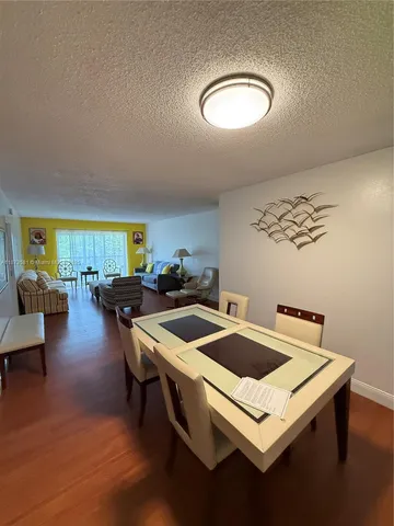 a kitchen with a stove a table and chairs