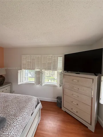 a bedroom with a bed and flat screen tv