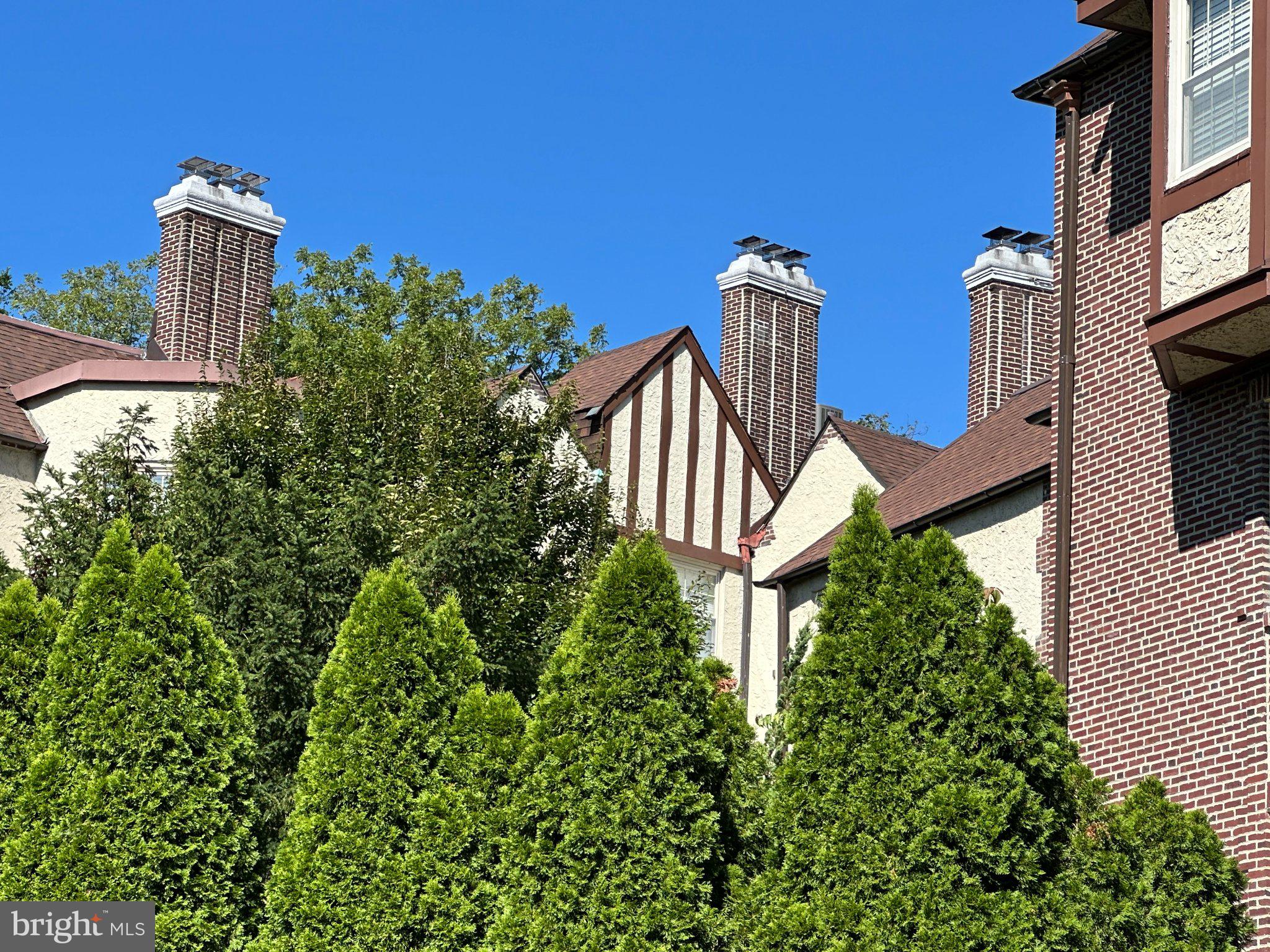 212 Idris Road, Unit F3 Merion Station, PA 19066 - Photo 24 of 25 Charming Tudor architecture, lush green surrounds.