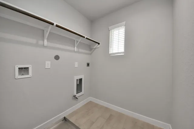 a view of a big room with windows and chandelier