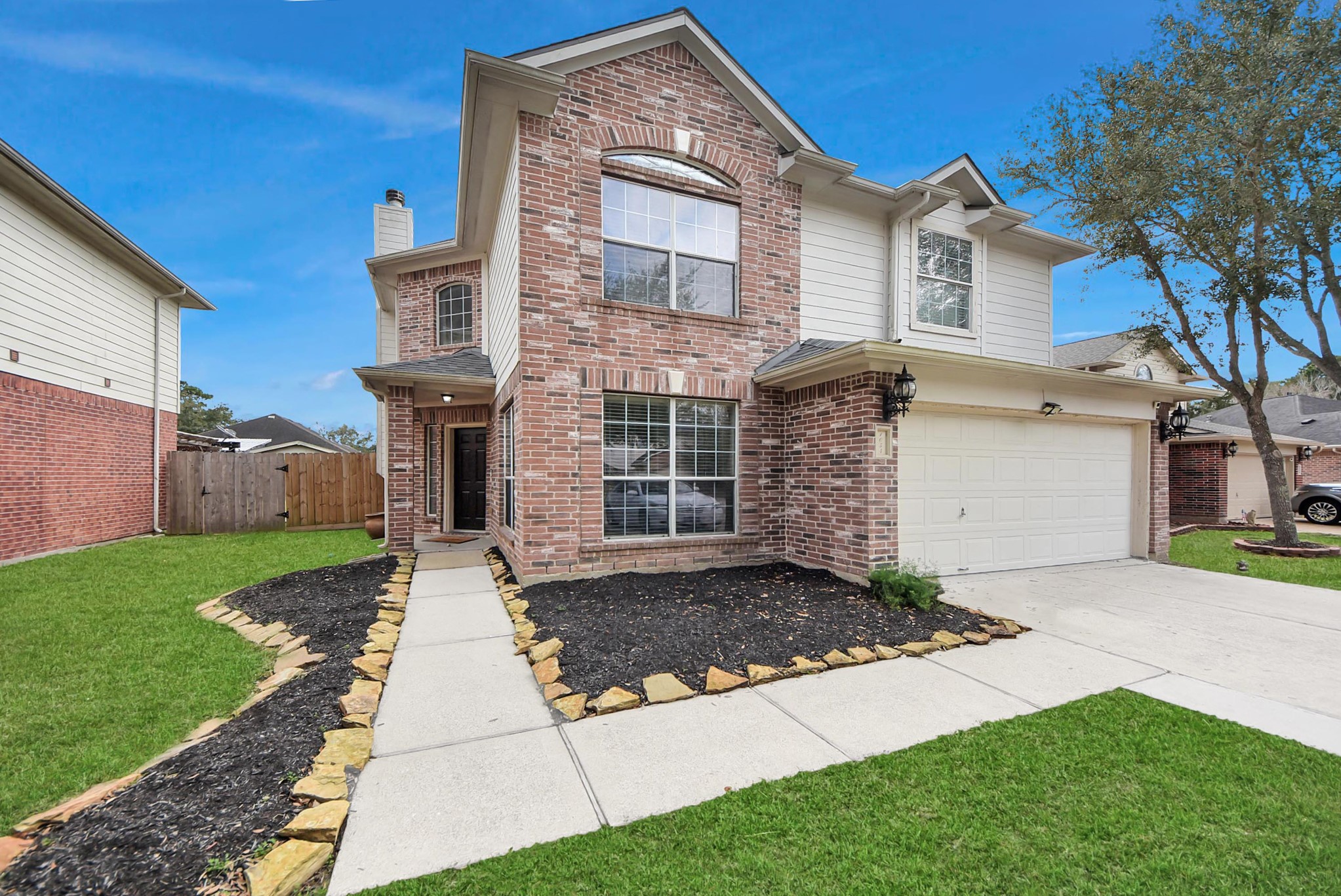 1054 Inverness Cove Dickinson, TX 77539 - Photo 1 of 28 a front view of a house with a yard and garage
