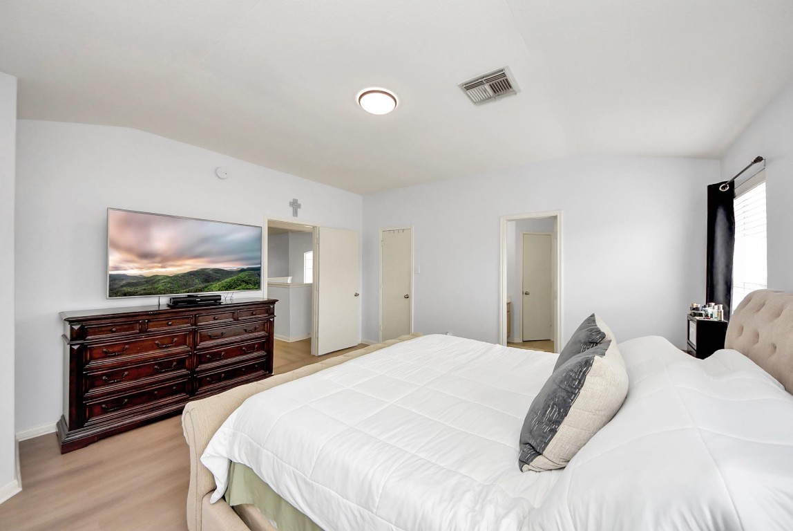 1054 Inverness Cove Dickinson, TX 77539 - Photo 18 of 28 a bedroom with a bed and a flat screen tv