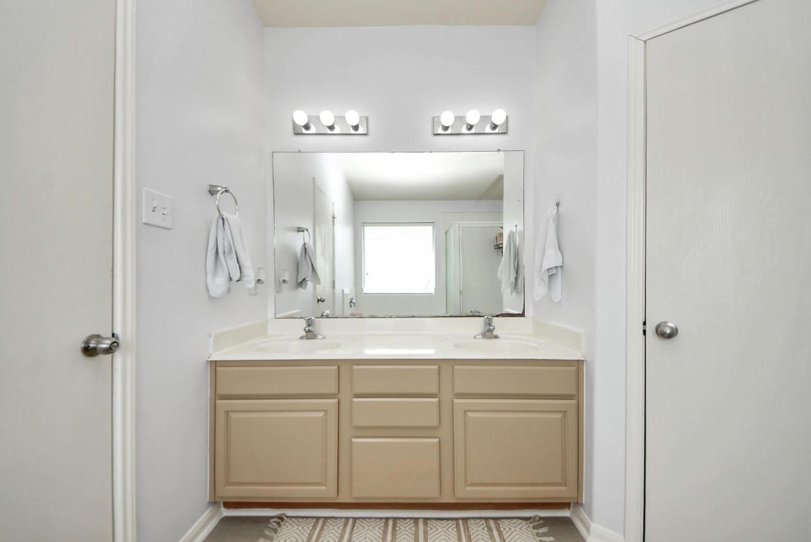 1054 Inverness Cove Dickinson, TX 77539 - Photo 19 of 28 a bathroom with a sink vanity granite and a mirror