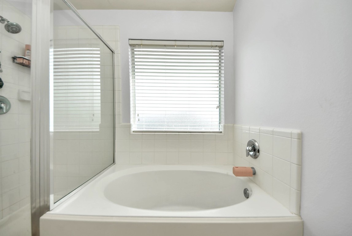 1054 Inverness Cove Dickinson, TX 77539 - Photo 20 of 28 a white bath tub sitting in a bathroom next to a window