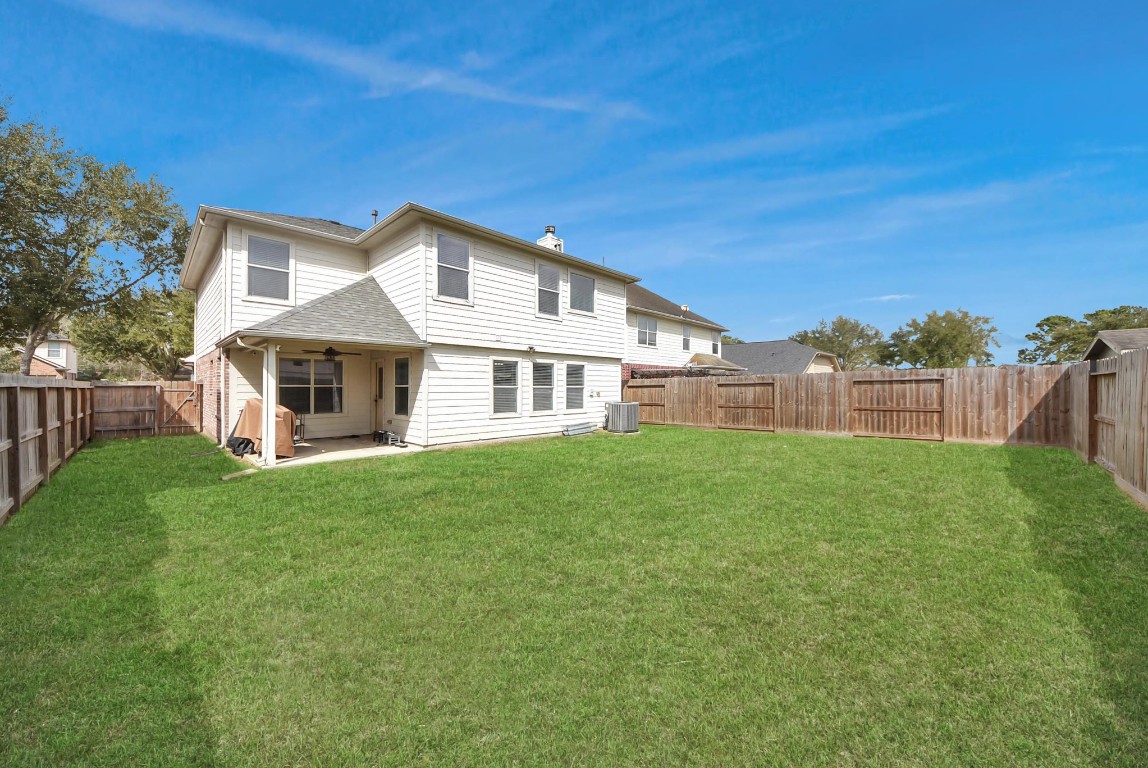 1054 Inverness Cove Dickinson, TX 77539 - Photo 26 of 28 a front view of a house with a garden