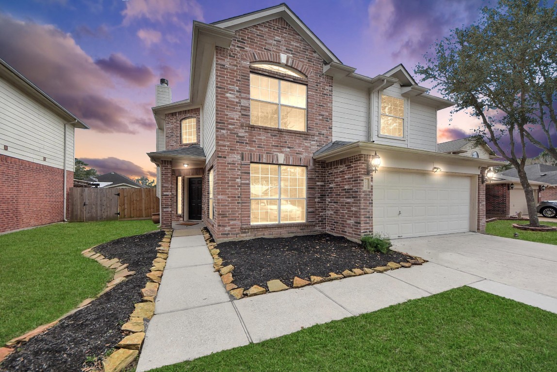 1054 Inverness Cove Dickinson, TX 77539 - Photo 28 of 28 a front view of a house with a yard
