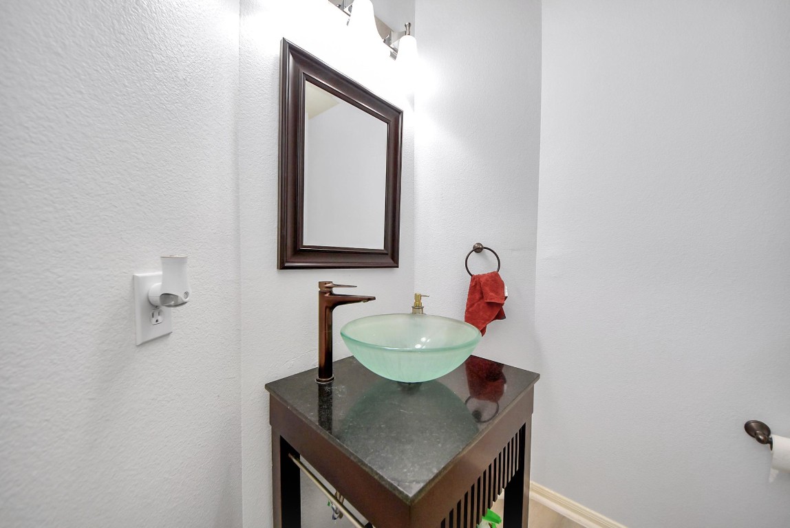1054 Inverness Cove Dickinson, TX 77539 - Photo 6 of 28 a bathroom with a sink vanity and a mirror