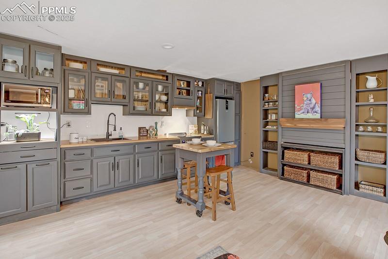 361 Willow Road Divide, CO 80814 - Photo 18 of 27 a kitchen with sink cabinets and dining table chair